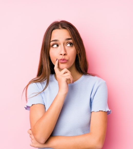 Young Caucasian Woman Wearing Ski Clothes Looking Sideways With Doubtful Skeptical Expression